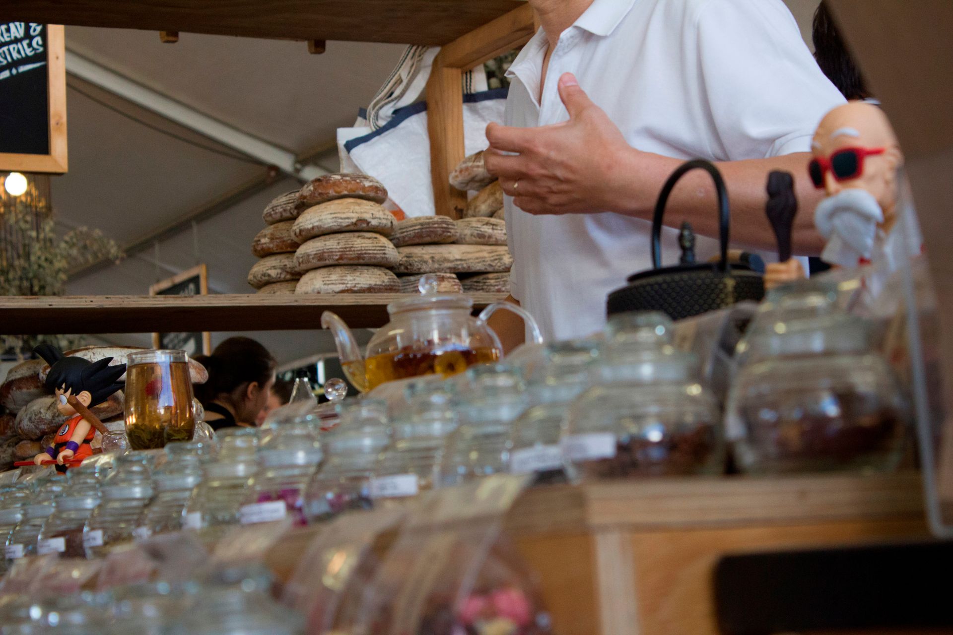 Trader answering customers questions at local market