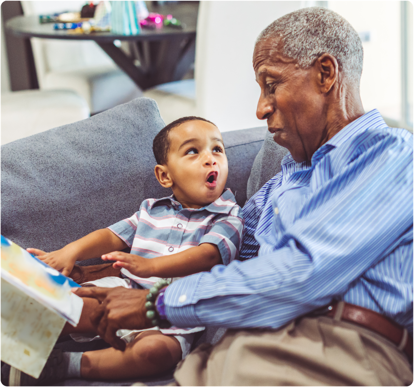 Grandpa reading a book to his grandson