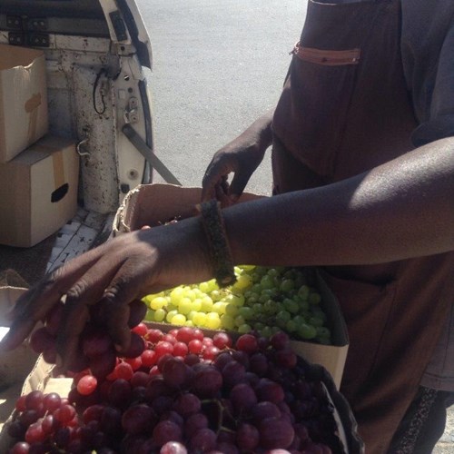 Hand reaching for grapes